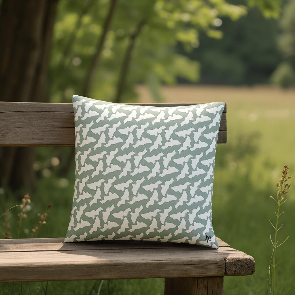 Patterned pillow on a wooden bench with a natural background
