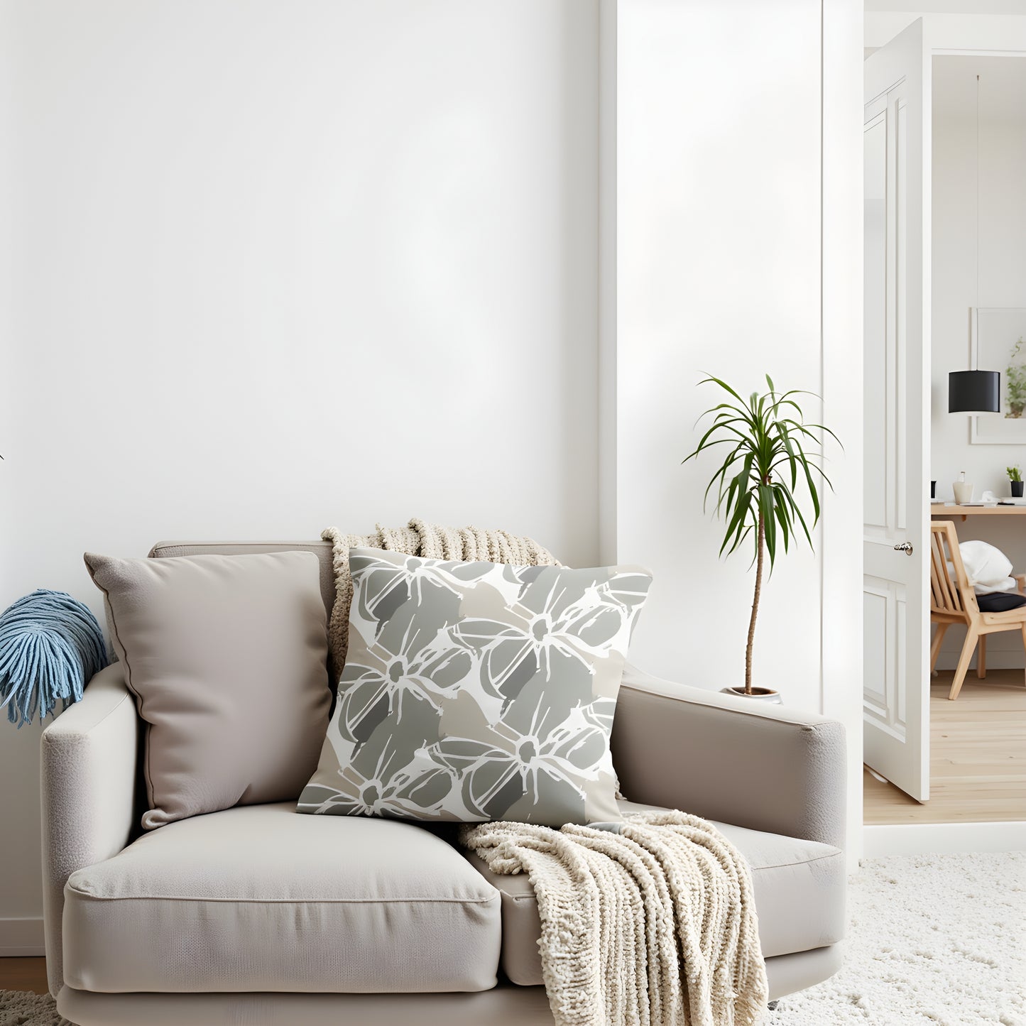 Beige sofa with decorative pillows and a blanket in a modern living room.