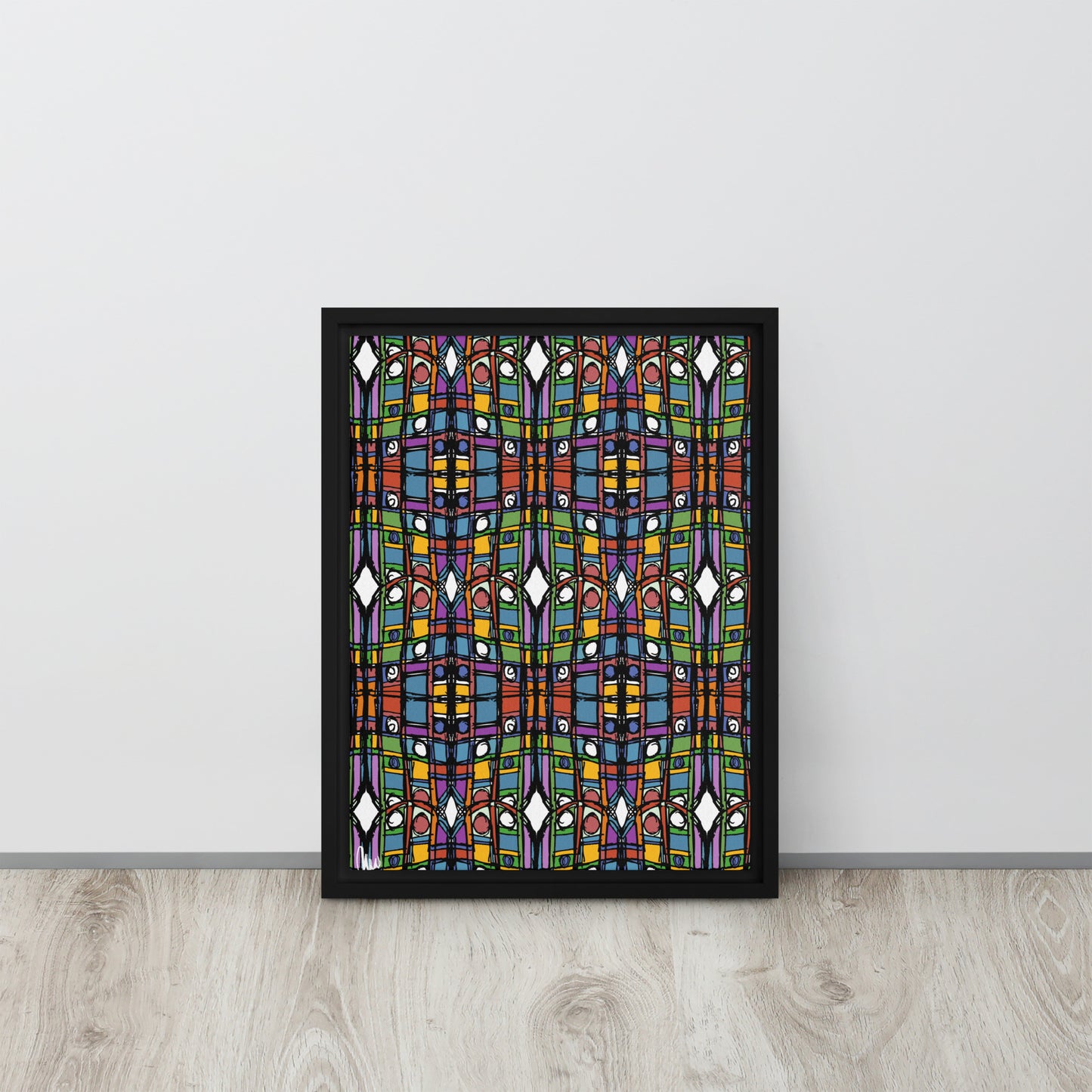 Framed abstract artwork with colorful geometric design on a white wall.