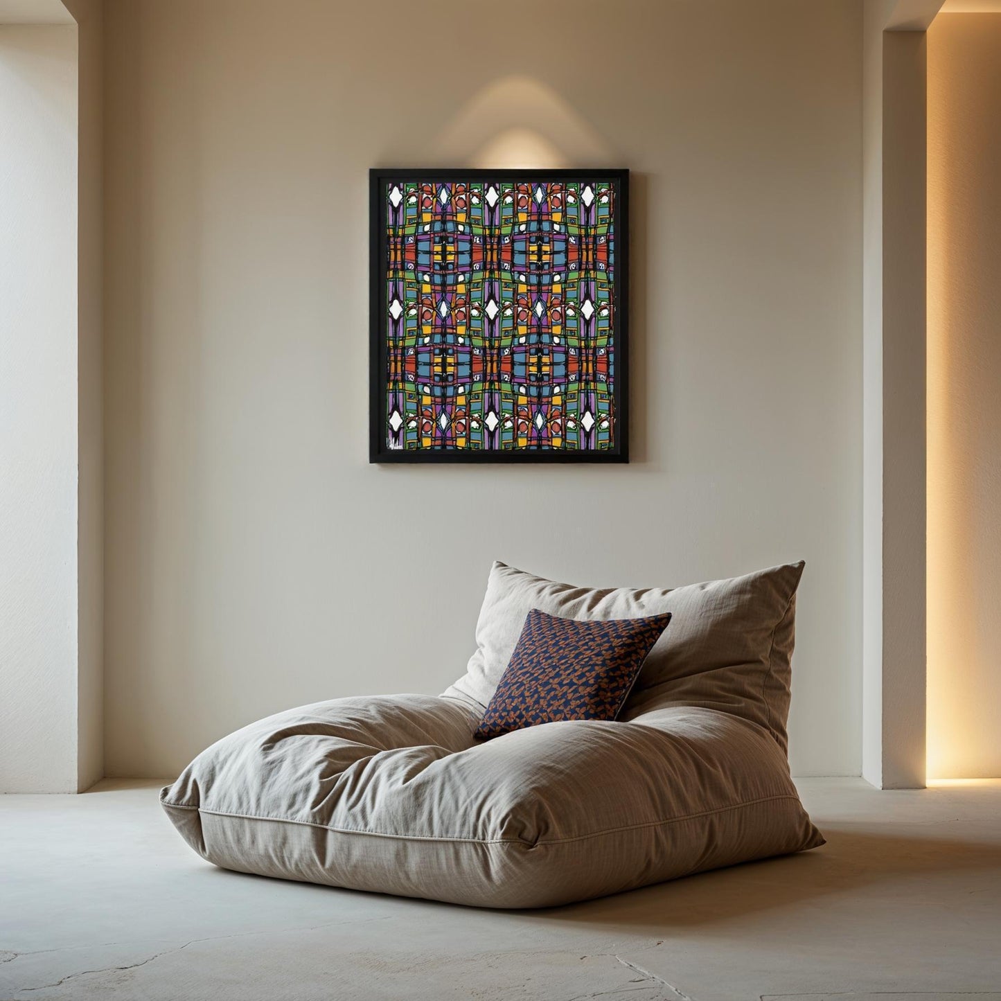 Decorative pillow on a large cushion with a colorful abstract painting on the wall.