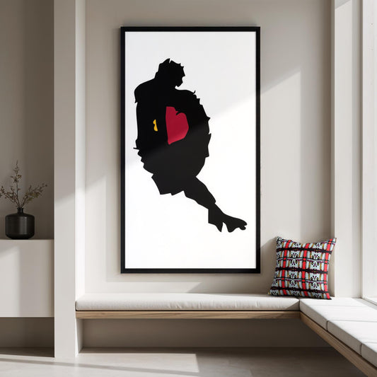Framed artwork of a silhouette with a red heart on a wall in a modern interior.
