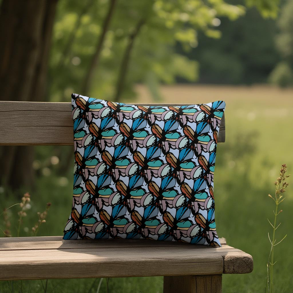 Decorative pillow with butterfly pattern on a wooden bench in a natural setting
