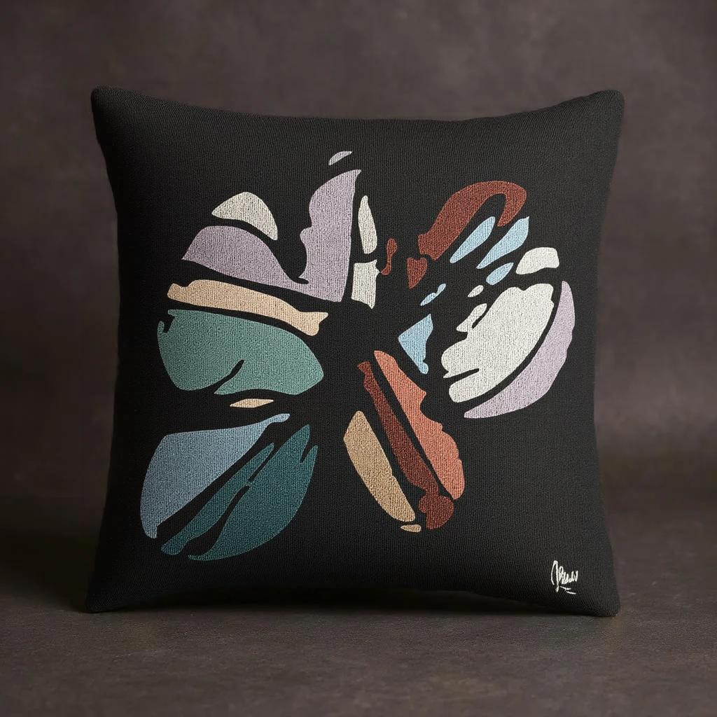 Decorative pillow with a colorful abstract design on a dark background