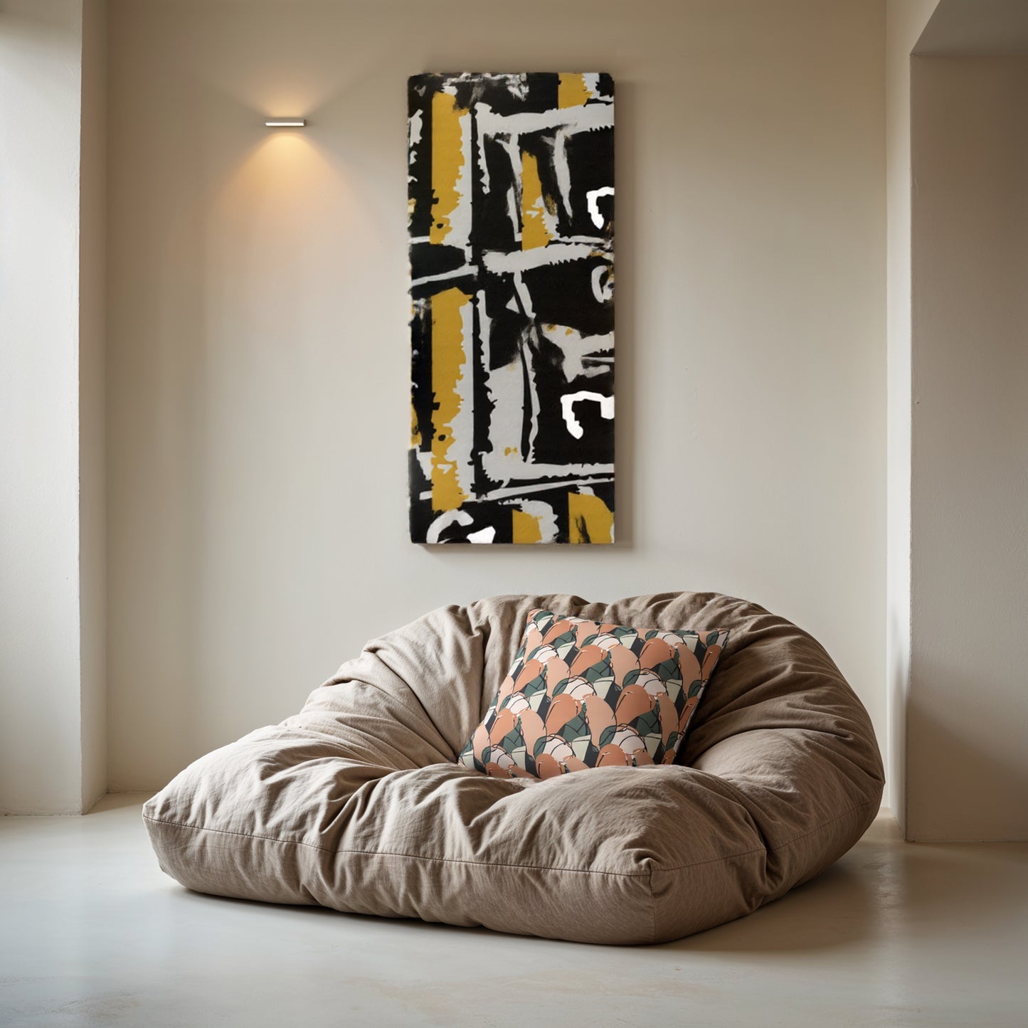 Beige bean bag chair with a patterned pillow against a wall with abstract art.
