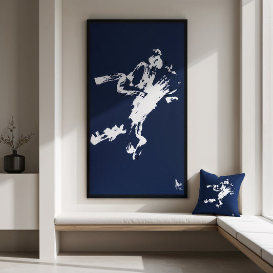 Framed artwork of a white silhouette on a blue background, placed above a window seat with a matching pillow.