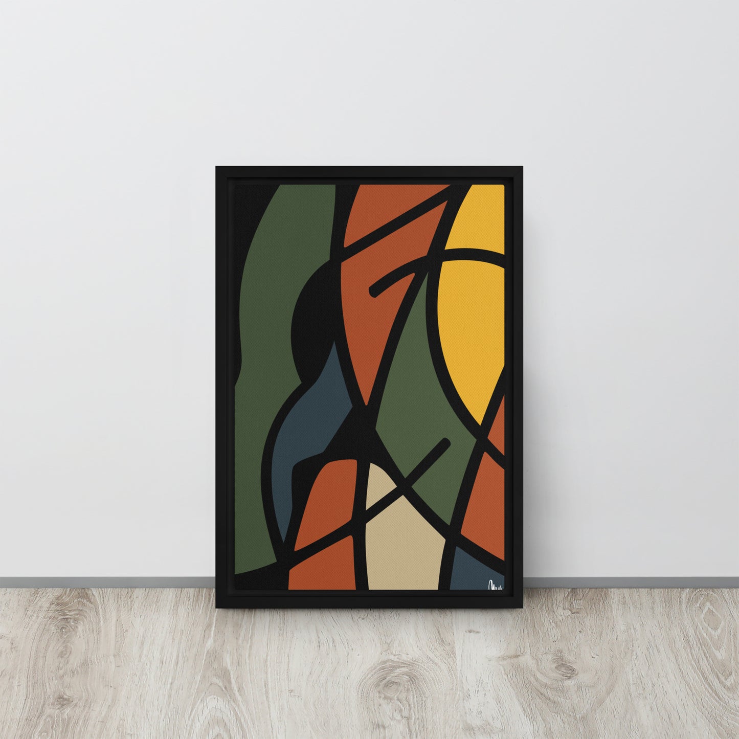 Abstract framed wall art print with geometric shapes in various colors on a white wall.