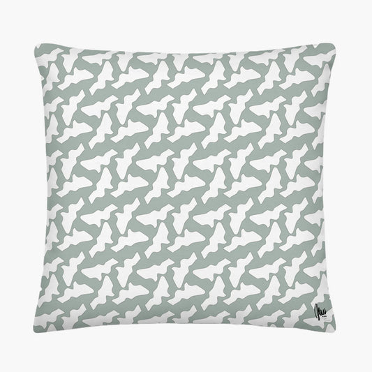 Patterned pillow with white shapes on a light gray background