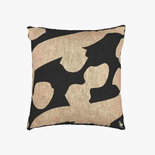 Decorative pillow with black abstract patterns on a beige background