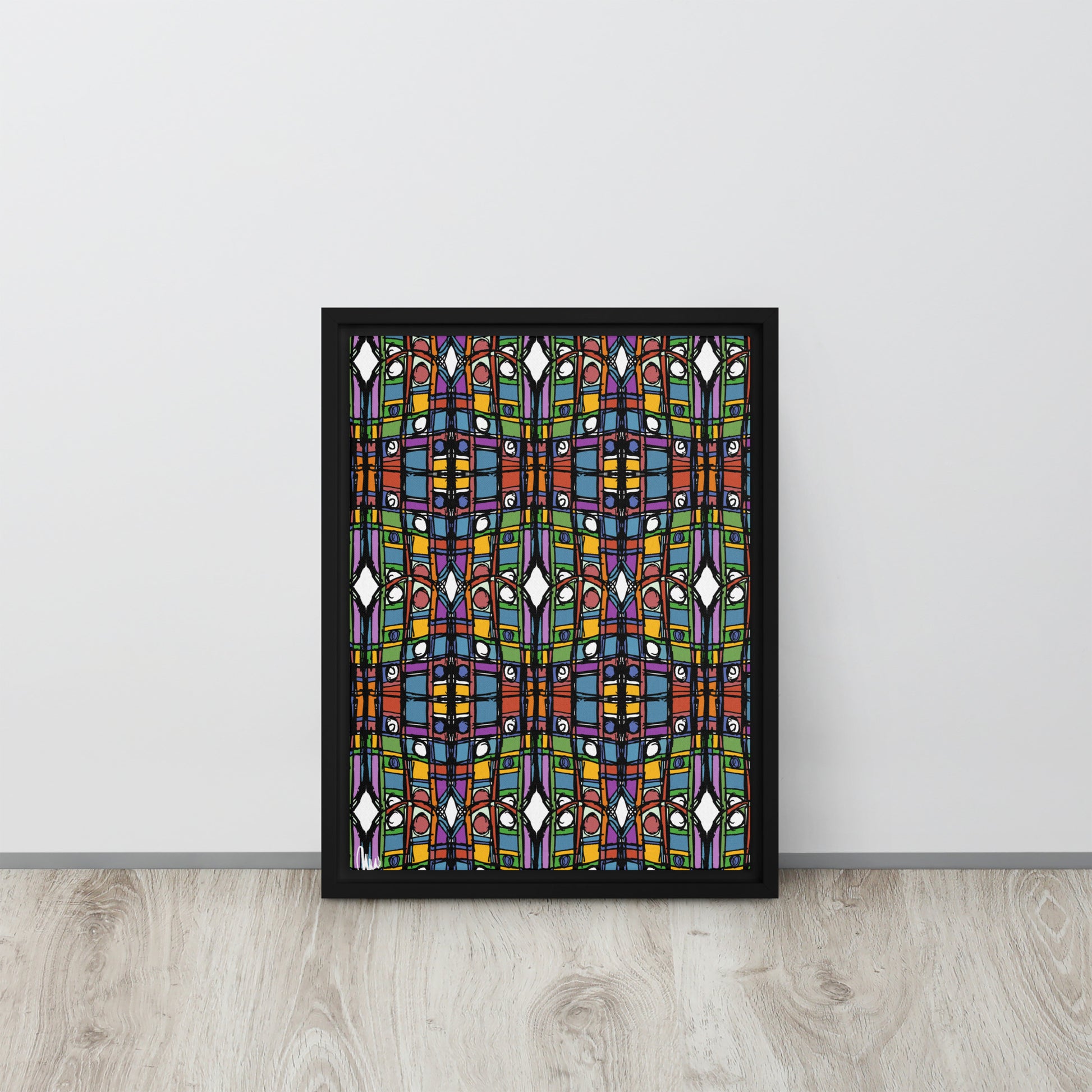 Framed abstract artwork with colorful geometric design on a white wall.