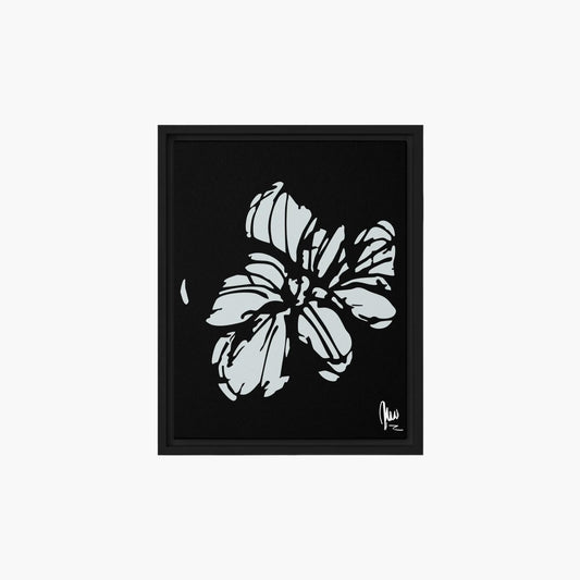 Framed artwork of a black and white floral design on a black background